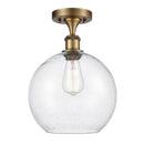 Athens Semi-Flush Mount shown in the Brushed Brass finish with a Seedy shade