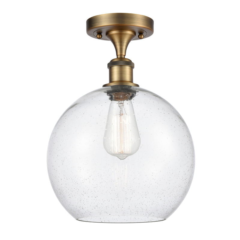 Athens Semi-Flush Mount shown in the Brushed Brass finish with a Seedy shade