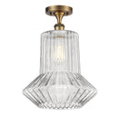 Springwater Semi-Flush Mount shown in the Brushed Brass finish with a Clear Spiral Fluted shade