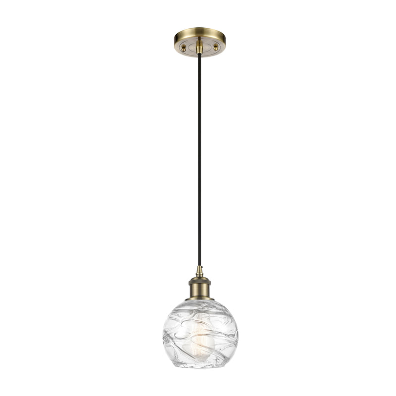 Deco Swirl Mini Pendant shown in the Antique Brass finish with a Clear shade