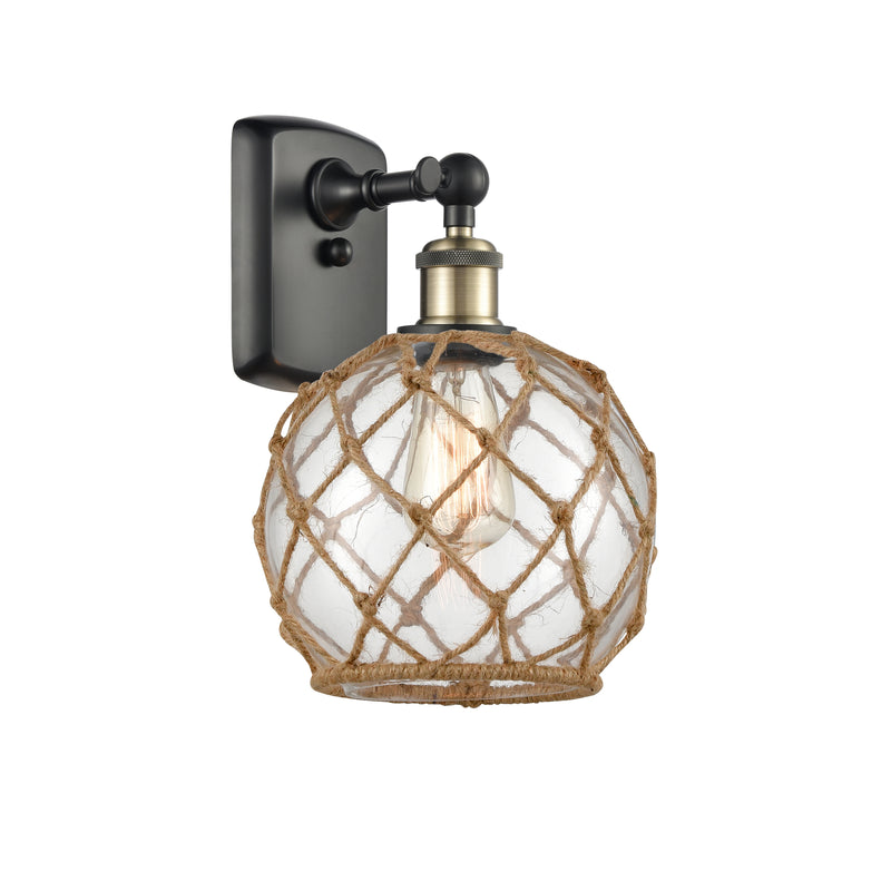 Farmhouse Rope Sconce shown in the Black Antique Brass finish with a Clear Glass with Brown Rope shade