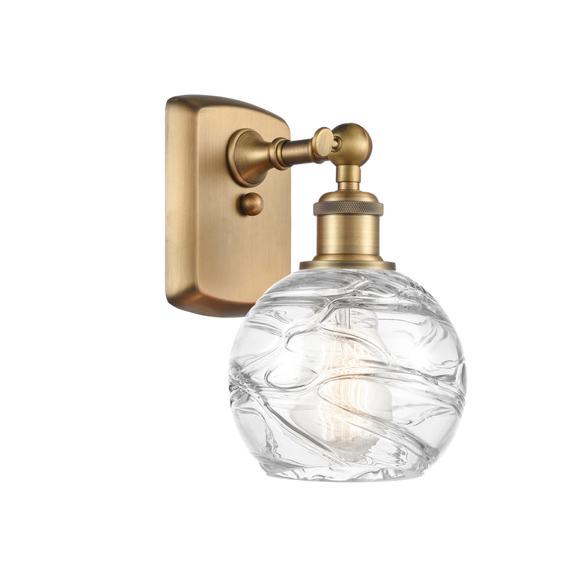 Deco Swirl Sconce shown in the Brushed Brass finish with a Clear shade