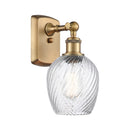 Salina Sconce shown in the Brushed Brass finish with a Clear Spiral Fluted shade