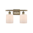 Cobbleskill Bath Vanity Light shown in the Antique Brass finish with a Matte White shade