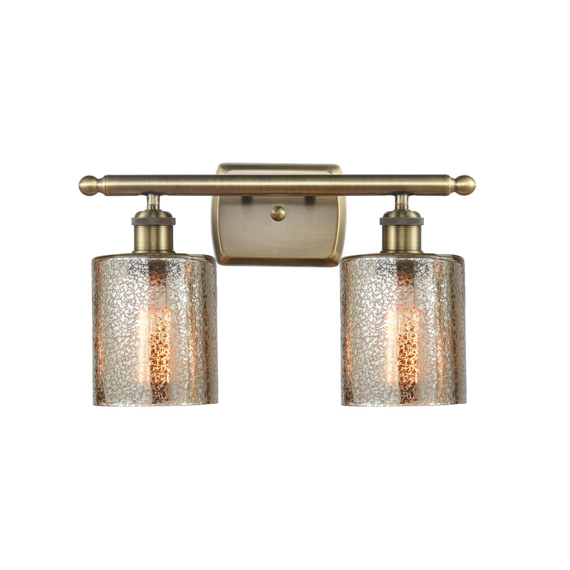 Cobbleskill Bath Vanity Light shown in the Antique Brass finish with a Mercury shade