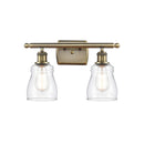 Ellery Bath Vanity Light shown in the Antique Brass finish with a Clear shade
