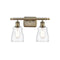 Ellery Bath Vanity Light shown in the Antique Brass finish with a Clear shade