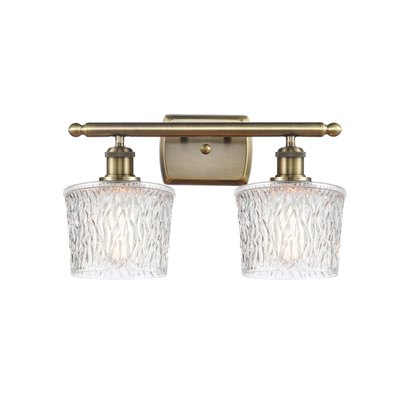 Niagra Bath Vanity Light shown in the Antique Brass finish with a Clear shade