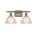 Arietta Bath Vanity Light shown in the Antique Brass finish with a Clear shade