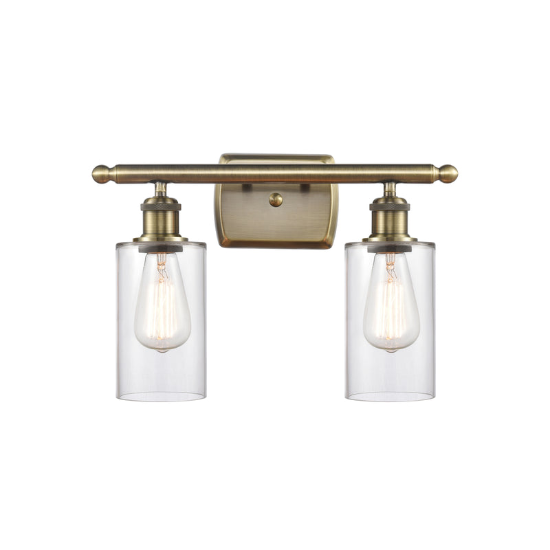 Clymer Bath Vanity Light shown in the Antique Brass finish with a Clear shade