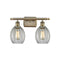 Eaton Bath Vanity Light shown in the Antique Brass finish with a Clear shade