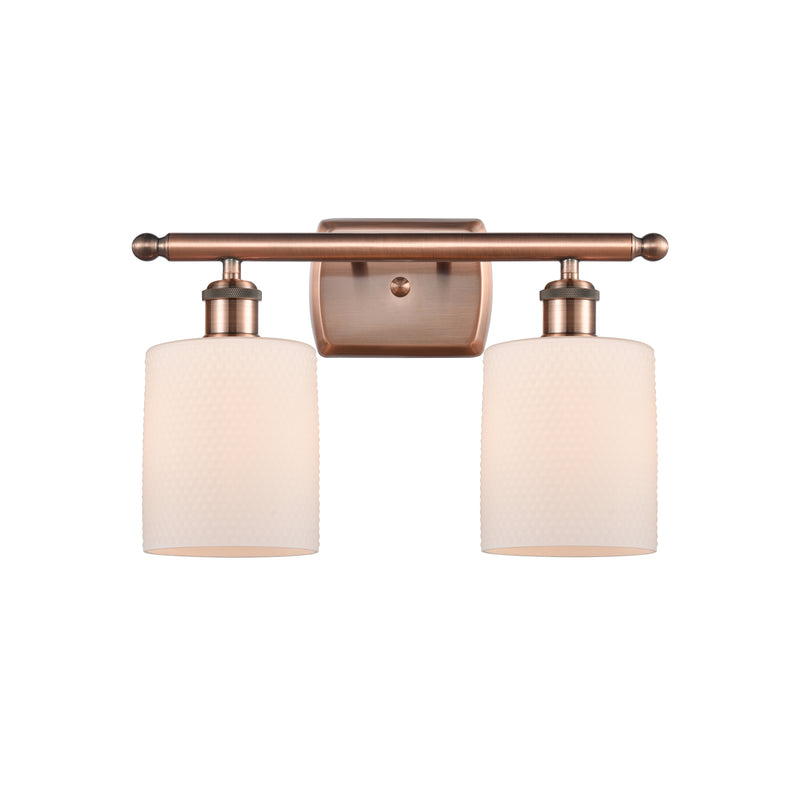 Cobbleskill Bath Vanity Light shown in the Antique Copper finish with a Matte White shade