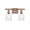 Hadley Bath Vanity Light shown in the Antique Copper finish with a Clear shade