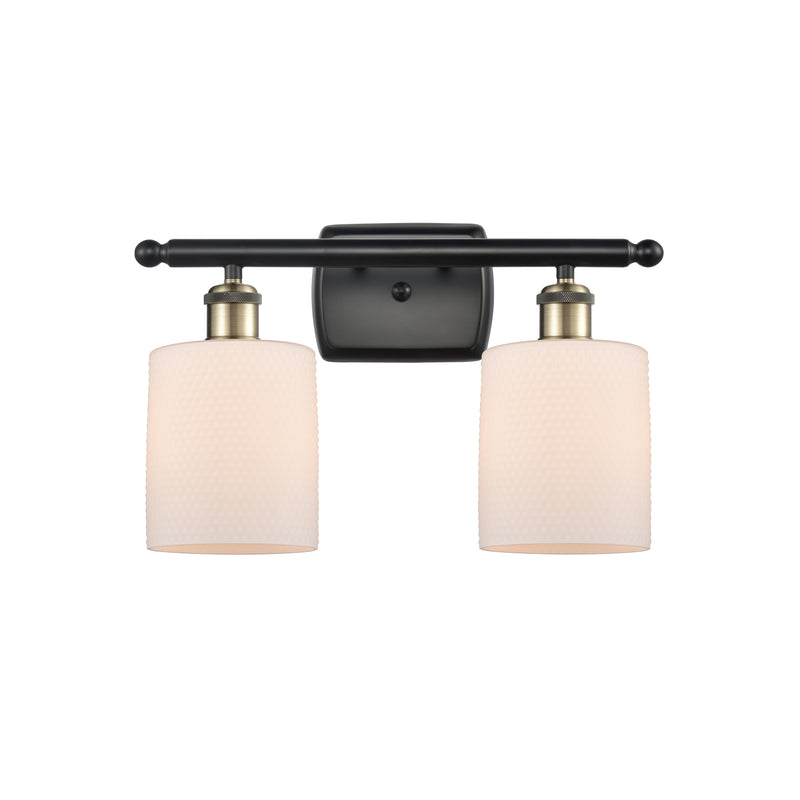 Cobbleskill Bath Vanity Light shown in the Black Antique Brass finish with a Matte White shade