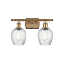 Salina Bath Vanity Light shown in the Brushed Brass finish with a Clear Spiral Fluted shade