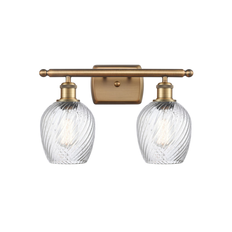 Salina Bath Vanity Light shown in the Brushed Brass finish with a Clear Spiral Fluted shade