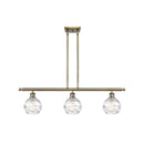 Deco Swirl Island Light shown in the Antique Brass finish with a Clear shade