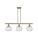 Deco Swirl Island Light shown in the Antique Brass finish with a Clear shade