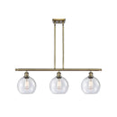 Athens Island Light shown in the Antique Brass finish with a Seedy shade