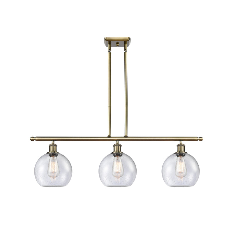 Athens Island Light shown in the Antique Brass finish with a Seedy shade