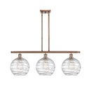 Deco Swirl Island Light shown in the Antique Copper finish with a Clear shade