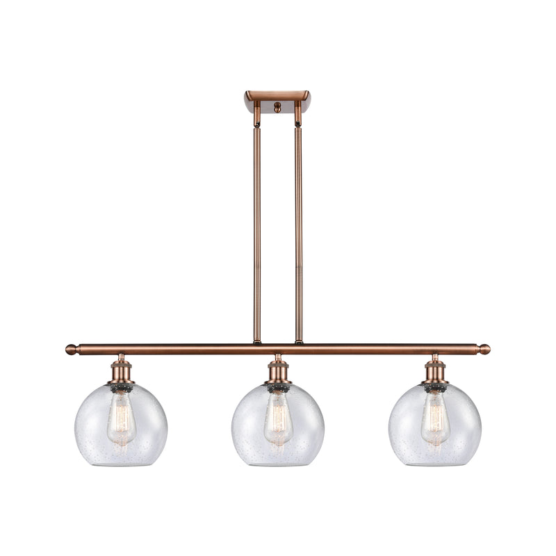 Athens Island Light shown in the Antique Copper finish with a Seedy shade