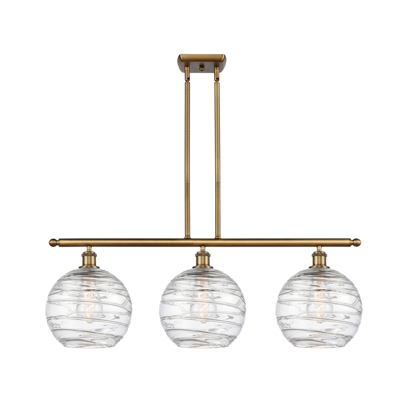 Deco Swirl Island Light shown in the Brushed Brass finish with a Clear shade