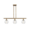 Deco Swirl Island Light shown in the Brushed Brass finish with a Clear shade