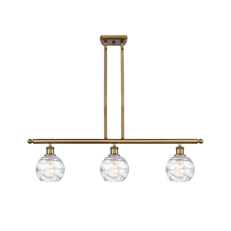 Deco Swirl Island Light shown in the Brushed Brass finish with a Clear shade