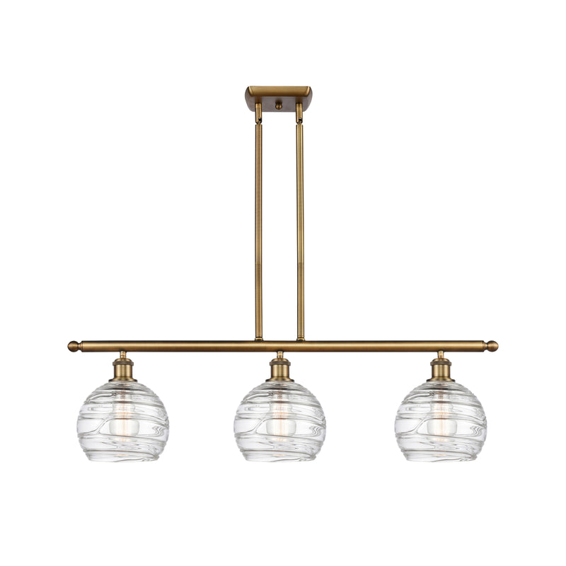 Deco Swirl Island Light shown in the Brushed Brass finish with a Clear shade