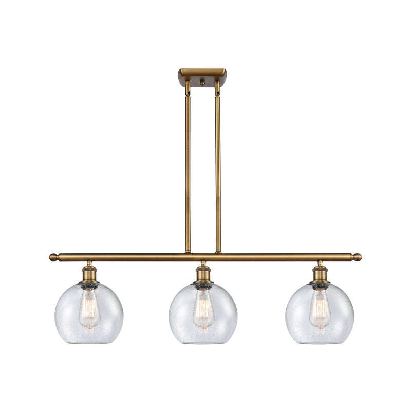 Athens Island Light shown in the Brushed Brass finish with a Seedy shade