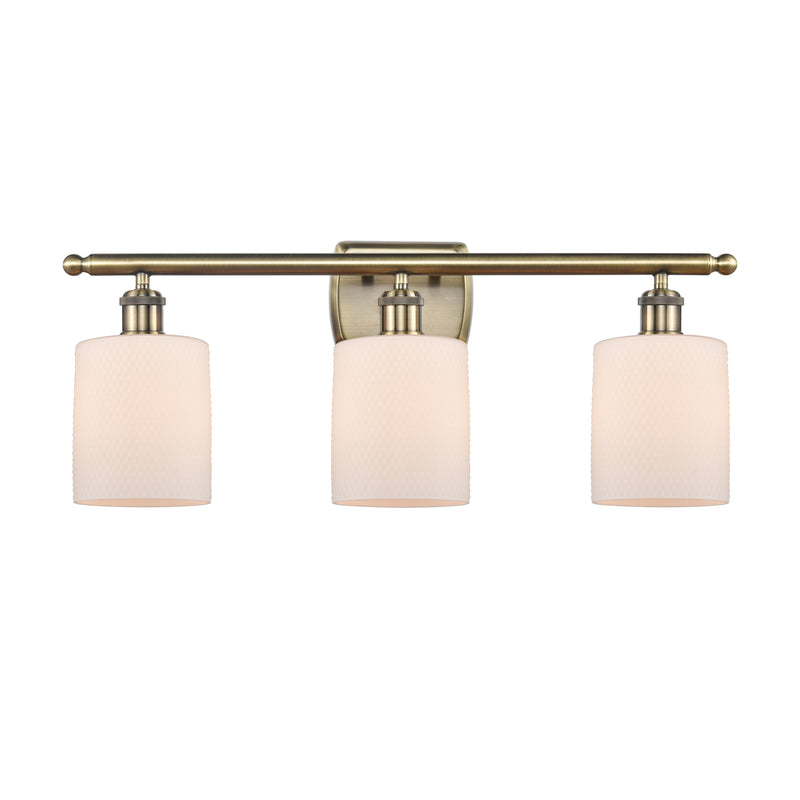 Cobbleskill Bath Vanity Light shown in the Antique Brass finish with a Matte White shade