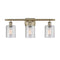 Cobbleskill Bath Vanity Light shown in the Antique Brass finish with a Clear shade