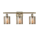 Cobbleskill Bath Vanity Light shown in the Antique Brass finish with a Mercury shade