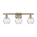 Deco Swirl Bath Vanity Light shown in the Antique Brass finish with a Clear shade