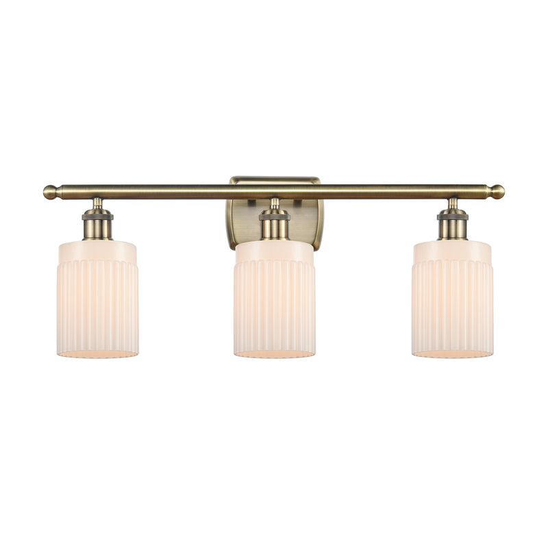 Hadley Bath Vanity Light shown in the Antique Brass finish with a Matte White shade