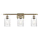 Hadley Bath Vanity Light shown in the Antique Brass finish with a Clear shade
