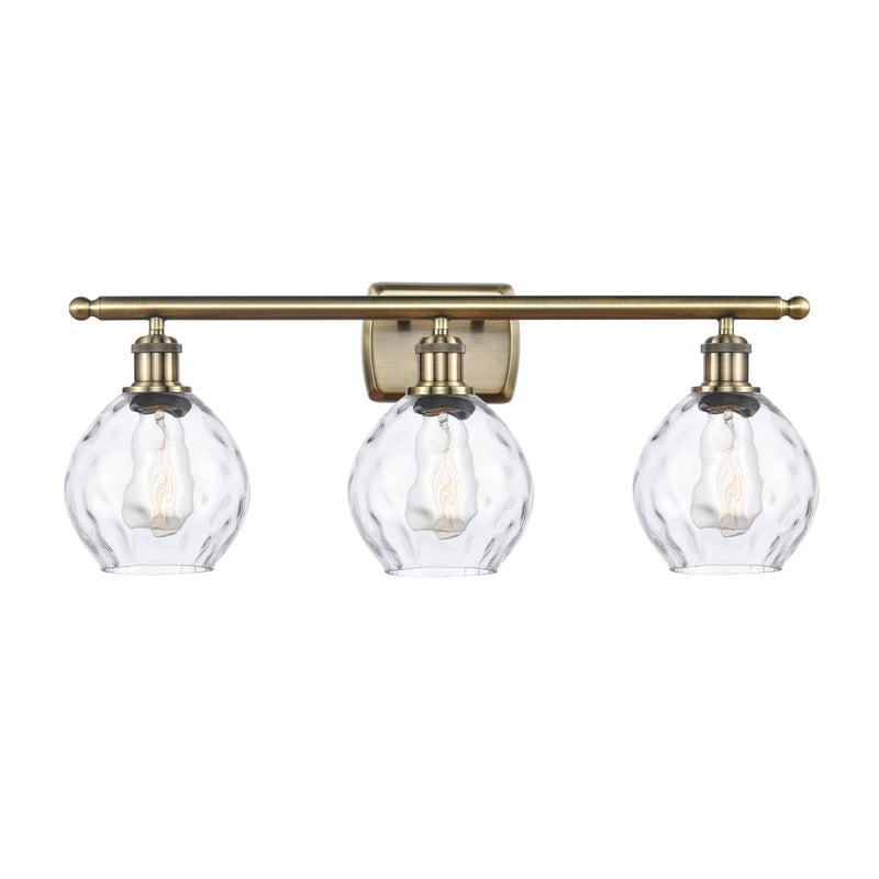 Waverly Bath Vanity Light shown in the Antique Brass finish with a Clear shade