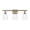 Ellery Bath Vanity Light shown in the Antique Brass finish with a Clear shade