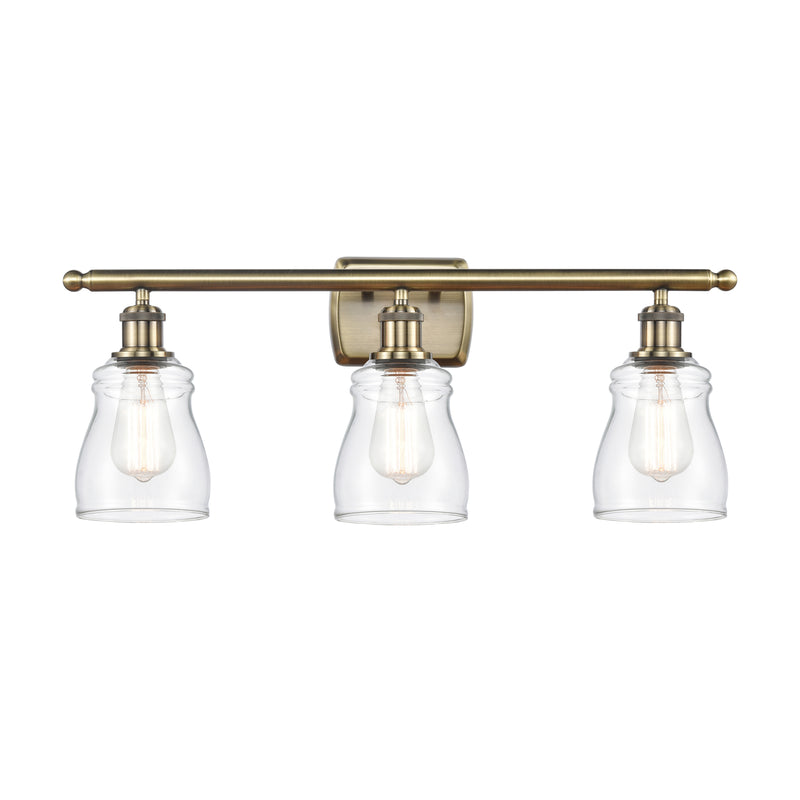 Ellery Bath Vanity Light shown in the Antique Brass finish with a Clear shade