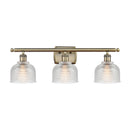 Dayton Bath Vanity Light shown in the Antique Brass finish with a Clear shade