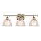 Arietta Bath Vanity Light shown in the Antique Brass finish with a Clear shade