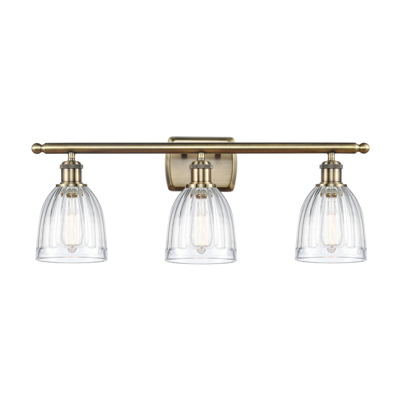 Brookfield Bath Vanity Light shown in the Antique Brass finish with a Clear shade