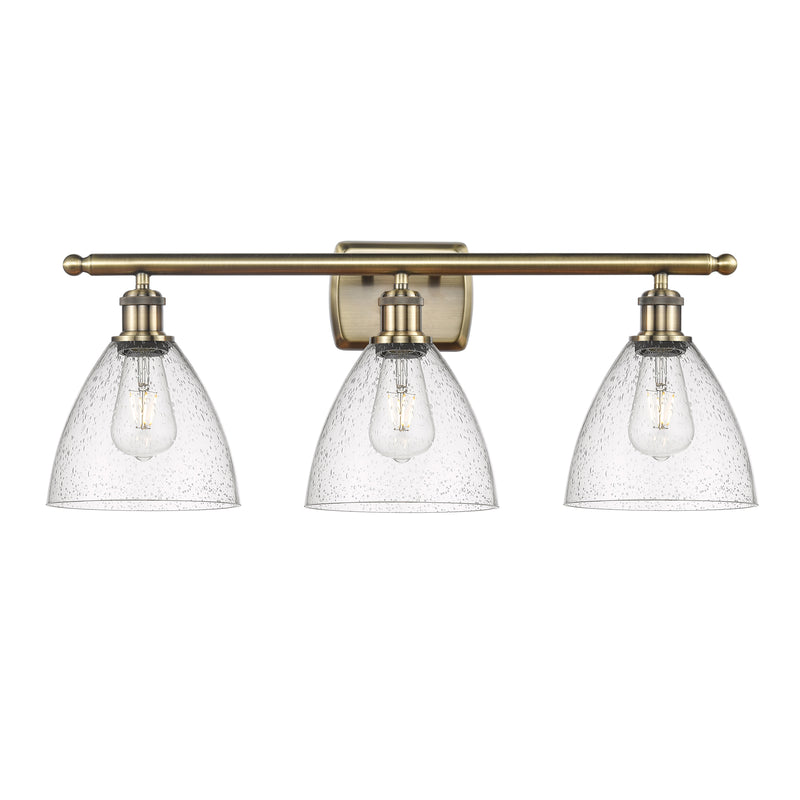 Ballston Dome Bath Vanity Light shown in the Antique Brass finish with a Seedy shade