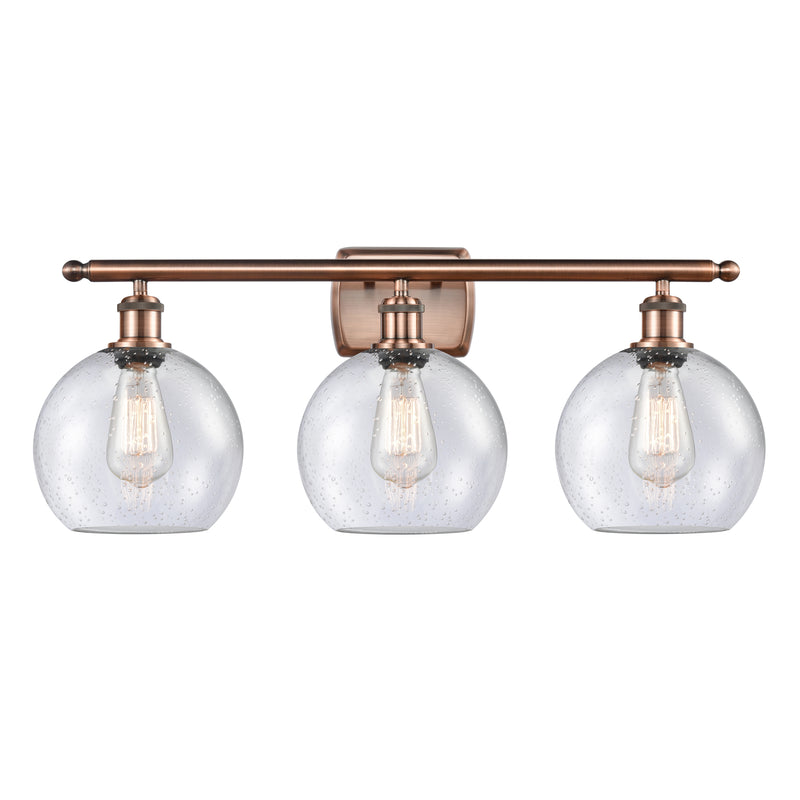 Athens Bath Vanity Light shown in the Antique Copper finish with a Seedy shade