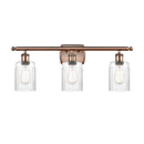 Hadley Bath Vanity Light shown in the Antique Copper finish with a Clear shade