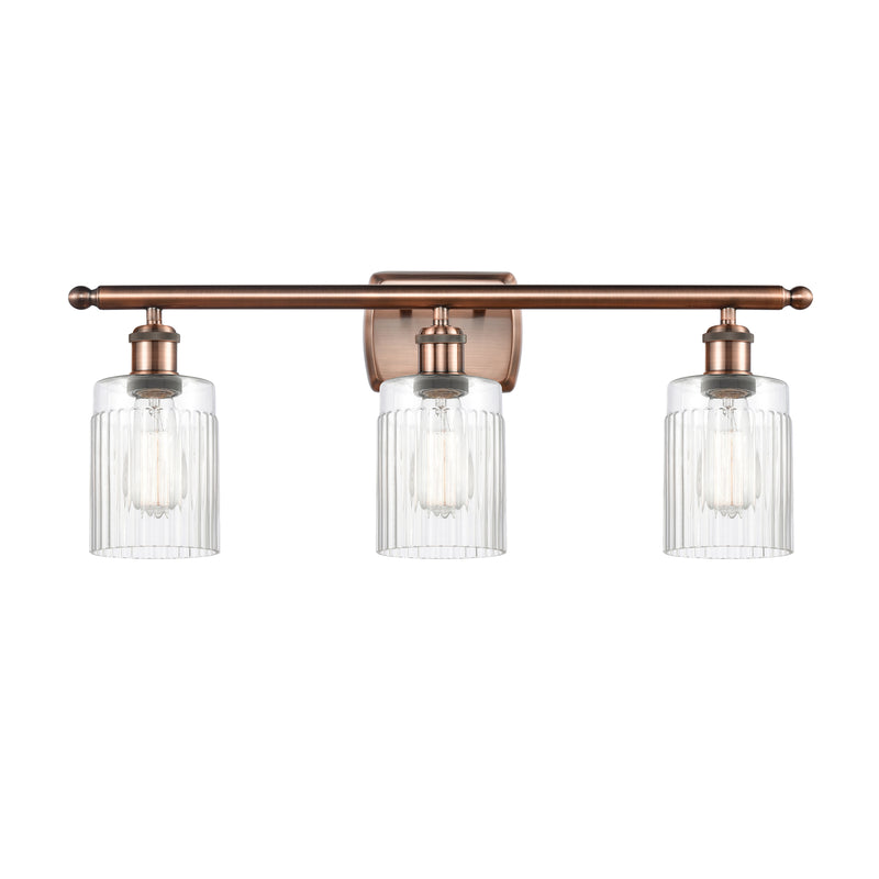 Hadley Bath Vanity Light shown in the Antique Copper finish with a Clear shade