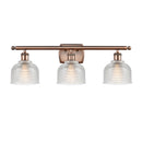 Dayton Bath Vanity Light shown in the Antique Copper finish with a Clear shade