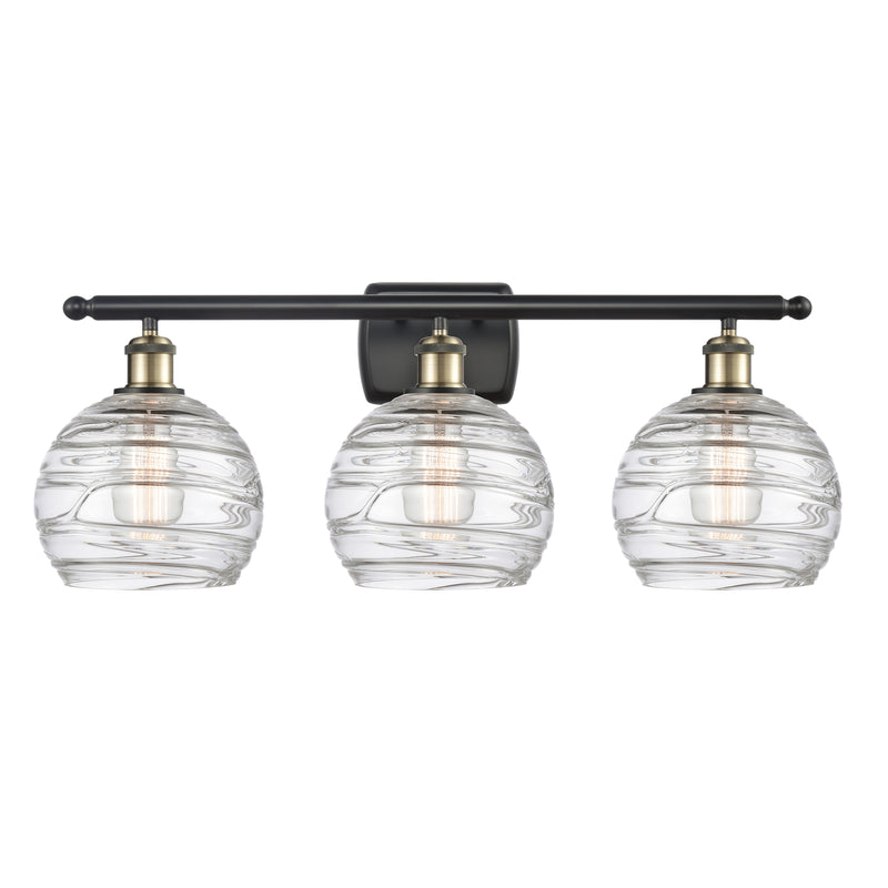 Deco Swirl Bath Vanity Light shown in the Black Antique Brass finish with a Clear shade