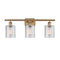 Cobbleskill Bath Vanity Light shown in the Brushed Brass finish with a Clear shade
